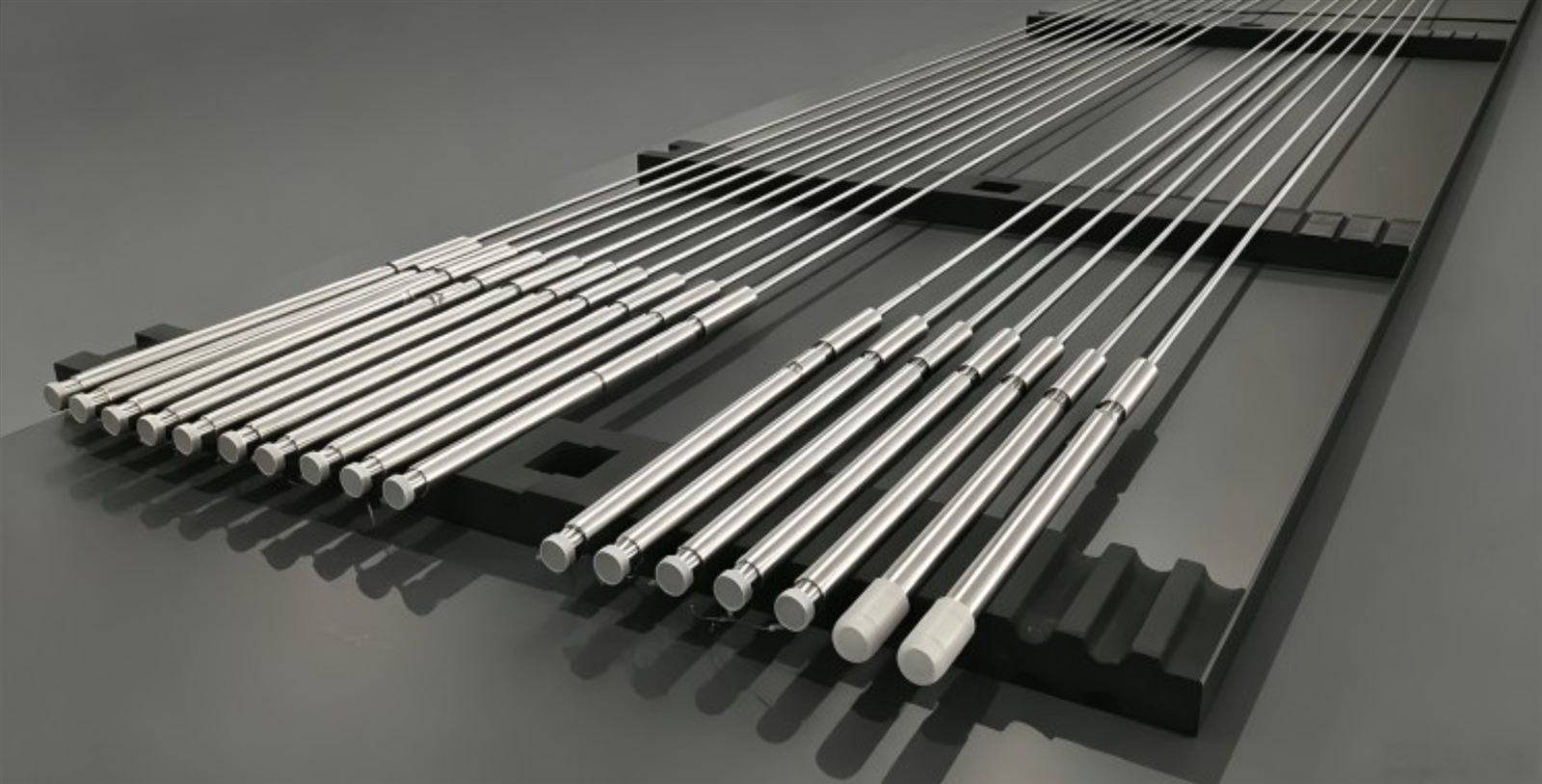 Chrome-coated precision shafts and rods on a plating rack - Ni + NTDC vs Ni + XADC nickel-chrome composite coating - JF Precision